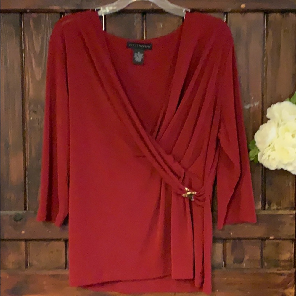 A gorgeous red v-neck blouse with a gold accent.